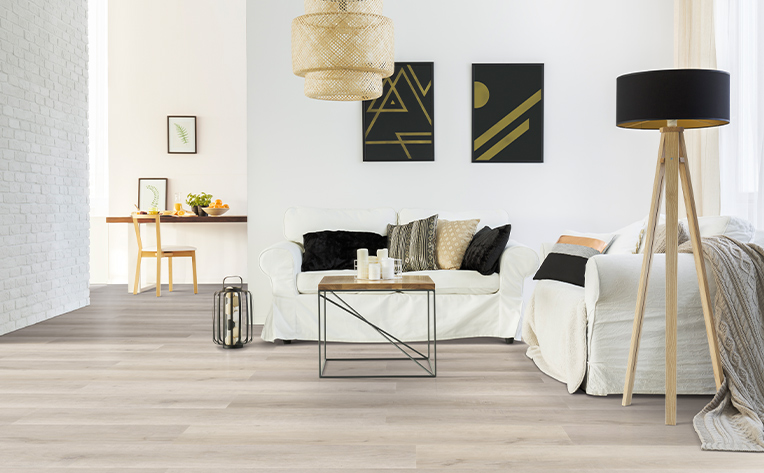 luxury vinyl living room with black lamp and white couch