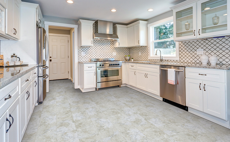 kitchen with lvp floors and white cabinetry